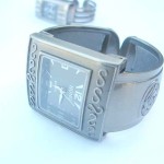 bangle-watches, S shape bangle watch with flower on band design S shape bangle watch with flower on band design