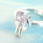 Outstanding 925. stamped silver ring with carrot holding a purple cz