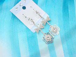Rhinestone silver finish butterfly knot earring holding flower