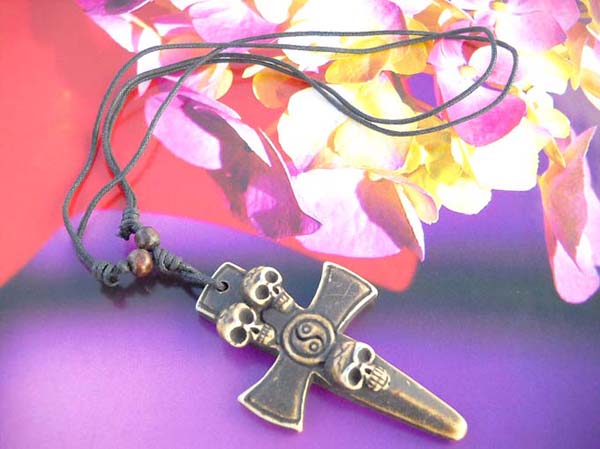 Cross with yang yin and triple skull resin necklace