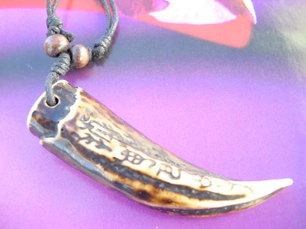 Elephant teeth shape pendant with tribal pattern