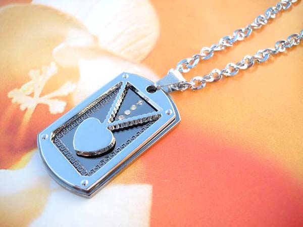 Rectangular pendant holding a mini heart necklace