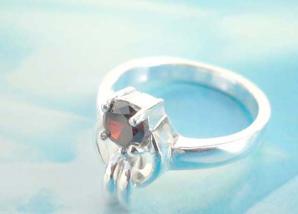 925. stamped silver ring with alien holding a red cz design