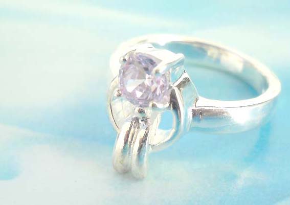 Outstanding 925. stamped silver ring with carrot holding a purple cz