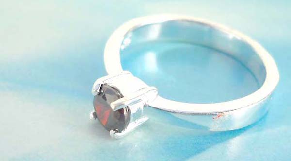 Favorite 925. stamped silver ring holding round ruby rhinestone