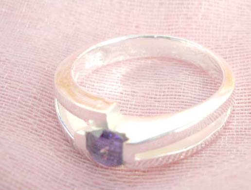 Outstanding 925. stamped silver ring with straight line holding purple crystal design