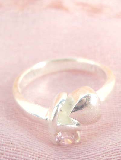 Outstanding 925. stamped silver ring with heart shape beside holding clear cz design