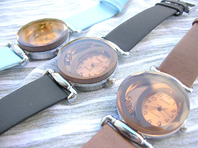 Antique bronze watch in assorted color with bronze bead run around beside the clock face